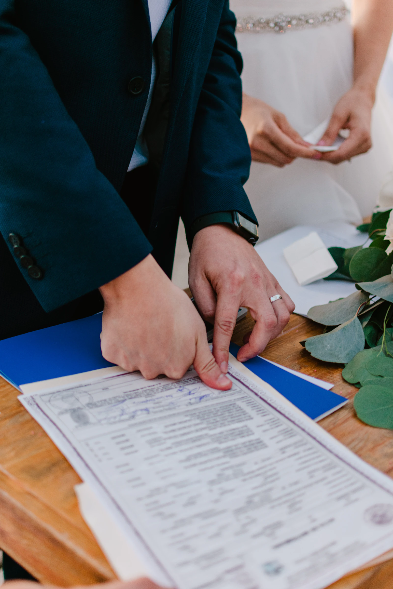 Pareja firmando el certificado de matrimonio durante una ceremonia de boda civil